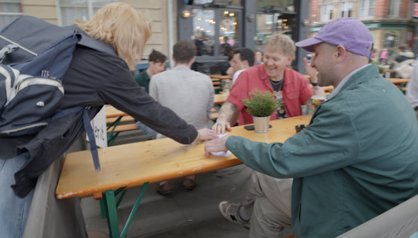 Participants socializing and connecting after the march at outdoor tables